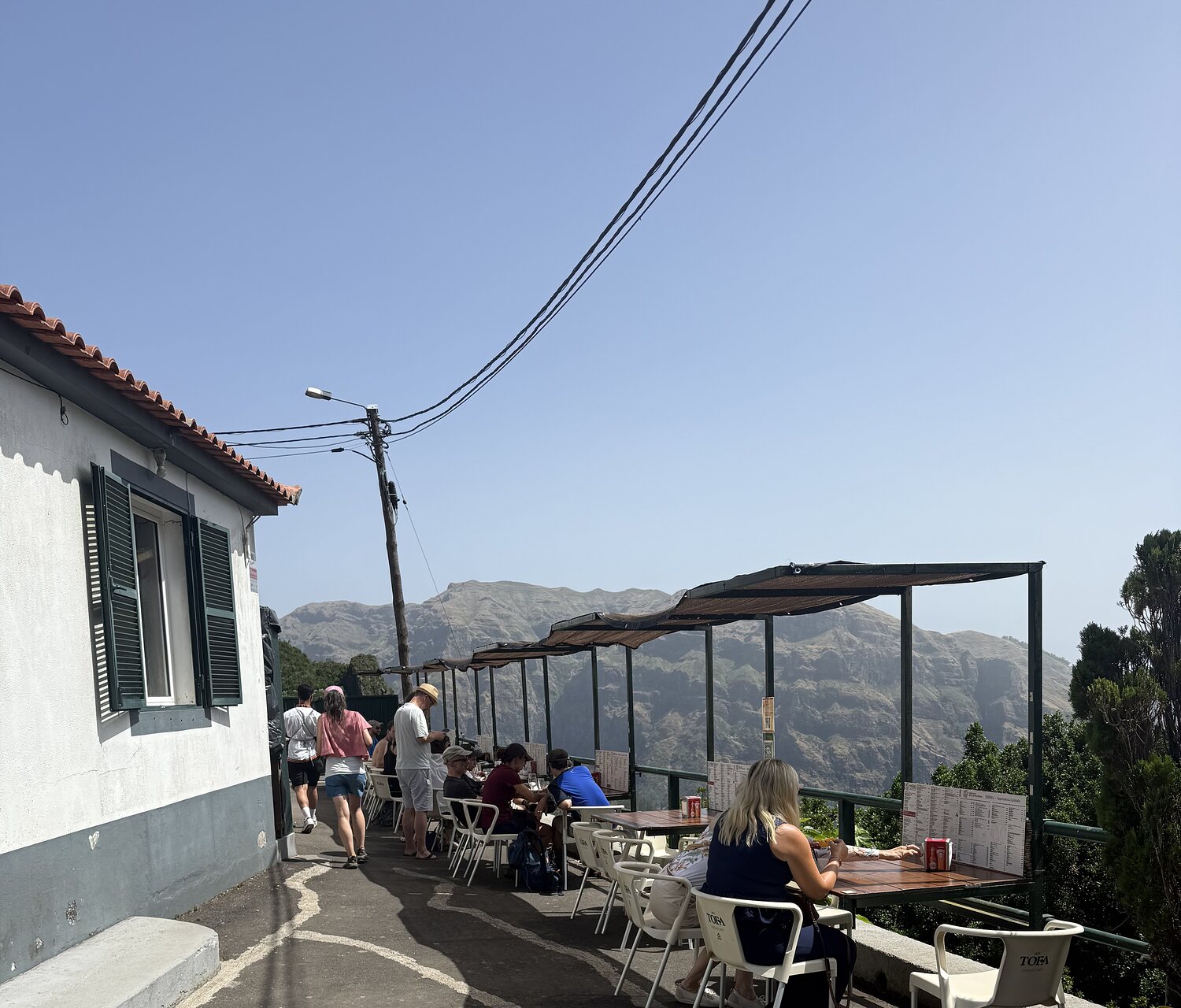 Diners at the terrace tables overlooking the mountains